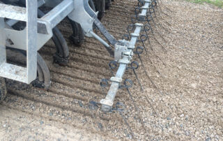 Harrow covering action on a road